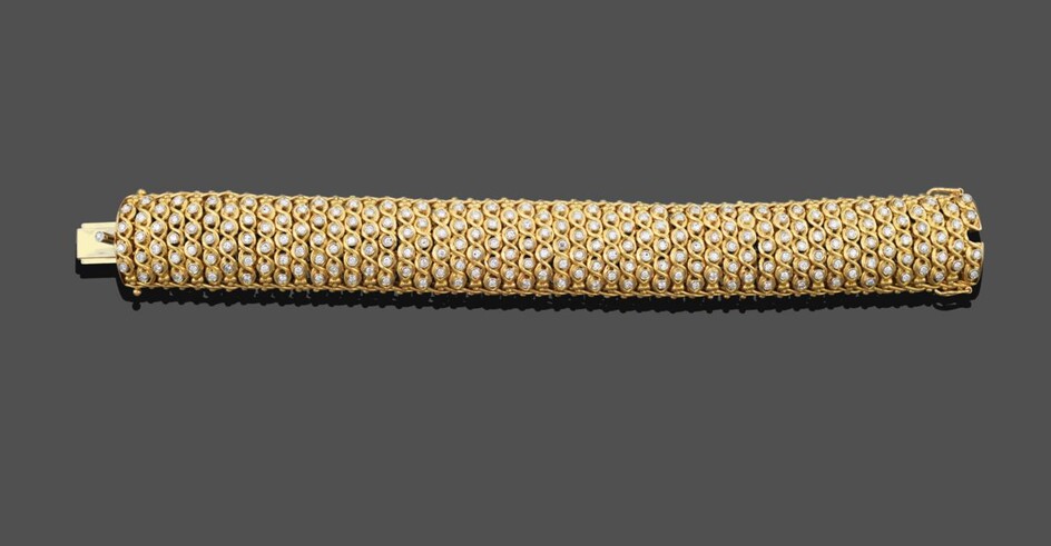 A Diamond Bracelet, the yellow broad fancy link bracelet set throughout with alternating columns of
