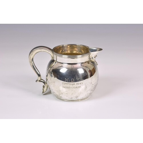A George VI silver baluster cream jug, Edward Barnard & Sons...