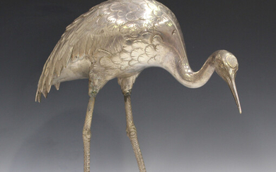 A Japanese silvered bronze model of a red-capped crane, Meiji period, standing with lowered head, un