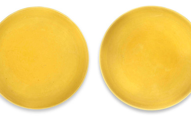 A NEAR PAIR OF IMPERIAL YELLOW-GLAZED SAUCER DISHES Yongzheng six-character...