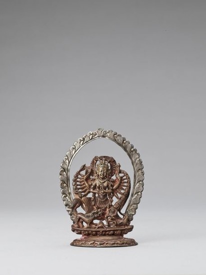 A NEPALESE COPPER AND SILVER REPOUSSÉ FIGURE OF...