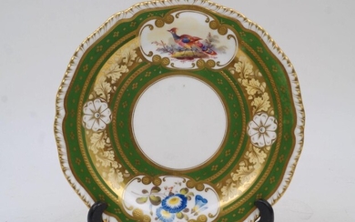 A New Hall Pottery side plate, circa 1810, decorated with vignettes of a bird and flowers within green and gilt foliate borders, bearing old label reading 'By Order of the Executors of the late Miss S.F. MALCOLM, Removed from 53, Carlton Mansions...