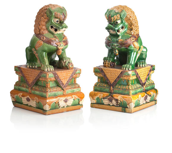 A PAIR OF LARGE POTTERY BUDDHISTIC LIONS