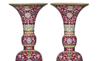 A PAIR OF RUBY-GROUND FAMILLE-ROSE 'BAJIXIANG' ALTAR VASES (GU), QIANLONG SEAL MARKS AND PERIOD