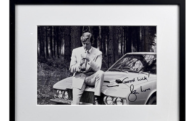 A Roger Moore signed photoprint