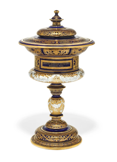 A SEVRES PORCELAIN PRESENTATION CUP AND COVER FOR THE 'PRIX DE SEVRES' AWARDED AT THE 'EXPOSITION UNIVERSELLE INTERNATIONALE' OF 1878 (COUPE 'COUTY') CIRCA 1879, IRON-RED DECORE MARK FOR 1879, GREEN STENCILED S. 79 LOZENGE MARK, INCISED POTTER'S MARK M...