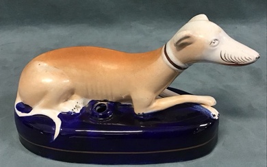 A Staffordshire ceramic inkwell in the form of a recumbent...