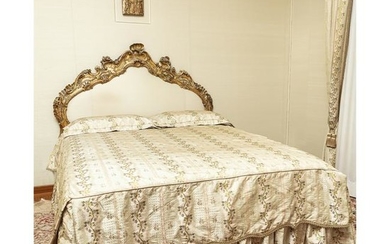 A Venetian gilt and graven wood bed