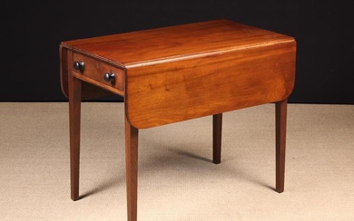 A Victorian Mahogany Pembroke Table. The drop leaf top with rounded corners and a reeded edge; the f