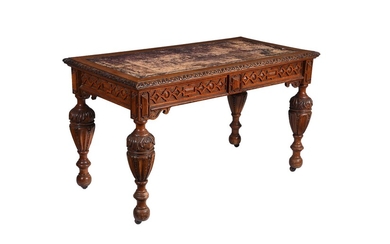 A Victorian carved oak writing table