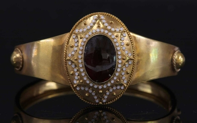 A Victorian gold garnet and enamel hinged bangle, c.1860