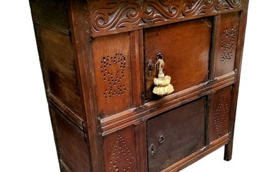 A William & Mary oak livery cupboard, the carved scrolli...