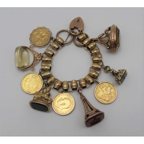 A YELLOW METAL CHARM BRACELET set with four framed full sove...