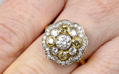 A brilliant-cut 'yellow' diamond and brilliant-cut diamond cluster ring.