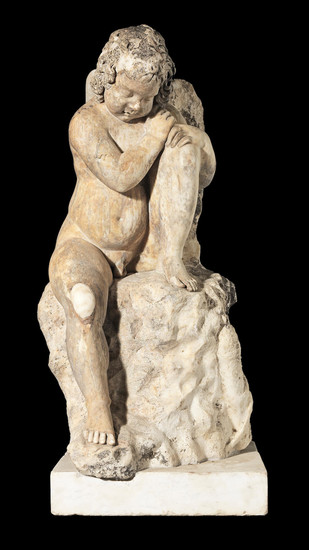 A carved marble figure of a putti