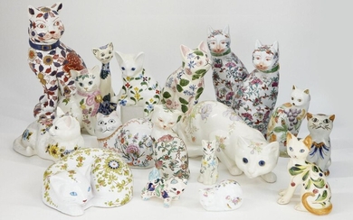 AMENDMENT: Please note that there are 18 cats in the lot and 19 as incorrectly stated in the catalogue. A collection of pottery cats, with floral decoration on a white ground, to include; a large Chinese cat, with painted marks to base, 34cm high...