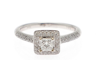 A diamond ring set with a princess-cut diamond weighing app. 0.50 ct. encircled by numerous diamonds, mounted in 14k white gold. Size 53.