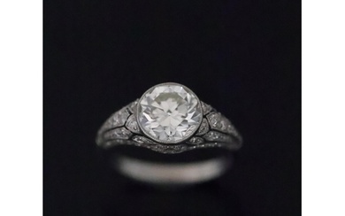 A fine diamond solitaire ring set with diamond shoulders, es...