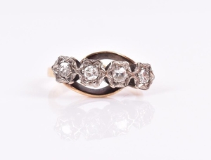 A four-stone diamond ring set with four round-cut diamonds,...