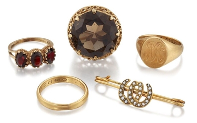 A group of jewellery, comprising: a smokey quartz single stone ring with pierced gallery and hoop; a 9ct gold, garnet three stone ring; a 22ct gold band ring, London hallmarks 4.4g; an 18ct gold signet ring, London hallmarks, 9g; and an Edwardian...