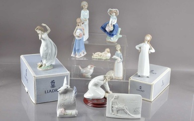 A group of nine Lladro figures and models and two collector's plaques