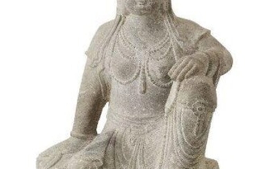 A large Chinese Tang-style carved stone figure of Guanyin, late Qing dynasty, depicted seated on a plinth with left hand clutching a rosary and resting on her raised left knee, 67cm high 清晚期 仿唐石雕觀音坐像