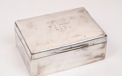 A large Edwardian silver cigar/cigarette box, London, c.1904, Joseph Braham, of plain rectangular form with presentation engraving to lid, 19.3 x 13.7 x 7.5cm; together with a silver paper knife with engine turned handle, Birmingham, c.1994...