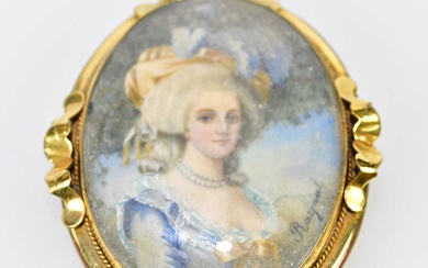 A late 19th century yellow metal framed oval portrait miniature...