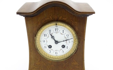 A late 19thC / early 20thC mahogany cased French mantle clock with satinwood inlay and white enamel