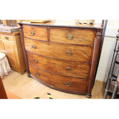 A late Regency mahogany bow fronted chest of two short and t...