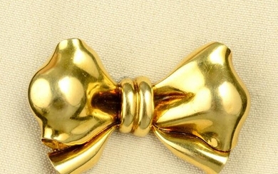 A mid 20th century gold bow brooch, by Bulgari. Length