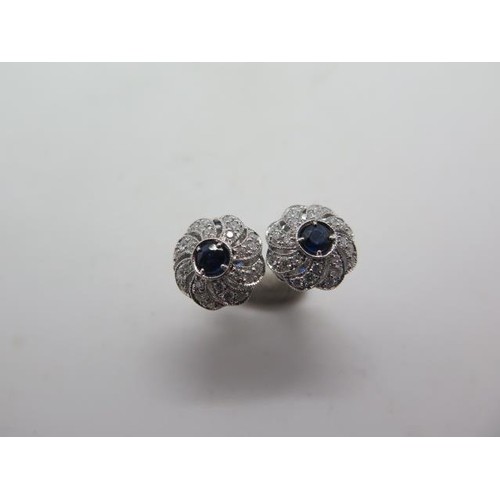 A pair of 18ct white gold sapphire and diamond swirl earring...