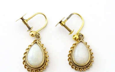 A pair of 9ct gold drop earrings set with opals. Approx 1" l...