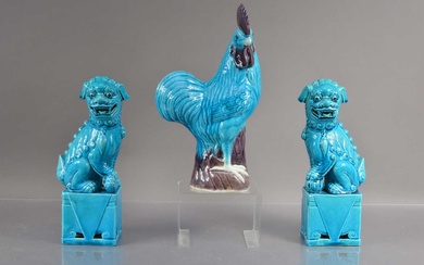 A pair of Chinese turquise glazed moulded posrcelain foo dogs or guardian lions
