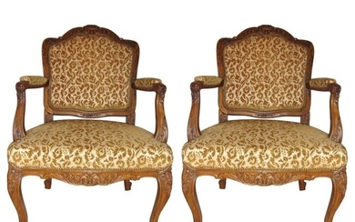A pair of Rococo craved Louis XV style armchairs. Each solid and study Bergere chair is stylized in