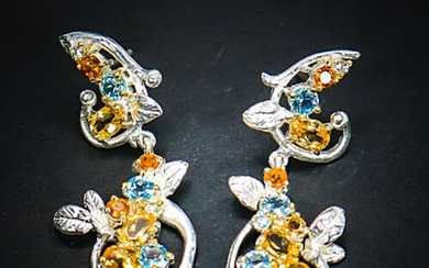 A pair of citrine and topaz ear pendants each set with numerous oval and circular-cut citrines and topazes, mounted in rhodium plated sterling silver. L. 4.5 cm