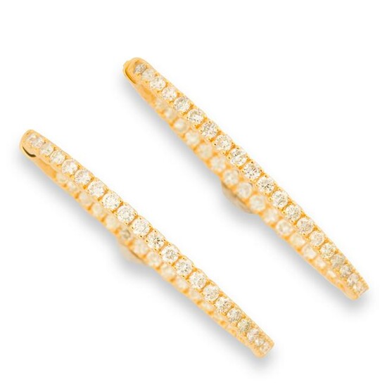 A pair of diamond and fourteen karat gold hoop earrings
