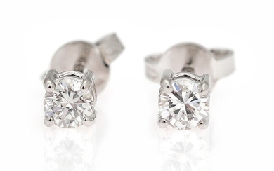 SOLD. A pair of diamond ear studs each set with a brilliant-cut diamond weighing a...