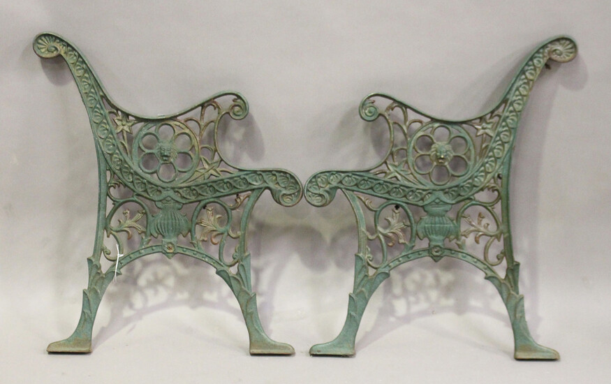 A pair of early 20th century green painted cast iron garden bench ends, height 72cm, depth 61cm.