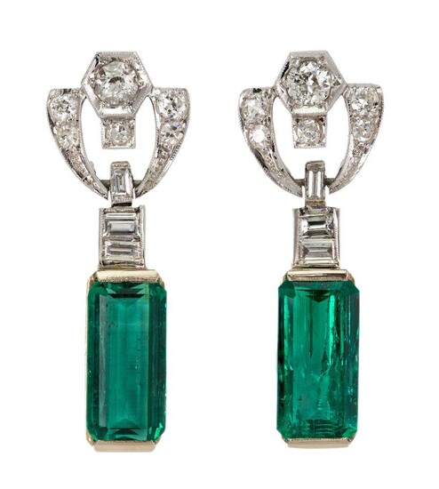 A pair of emerald and diamond earrings, each supporting a rectangular emerald drop each weigning 3.05 & 3.14 carats to an openwork scroll surmount set with circular-, single-cut and baguette diamonds, post fittings. Accompanied by report number...