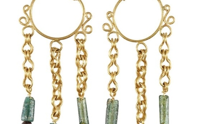 A pair of gold earrings in the Roman style, the hoop with twisted wire detail, each with three gold suspension chains below set with green glass bead and garnet, 6.5cm. long, 13.2 grams (2) Provenance: Private family collection formed in the 1970s