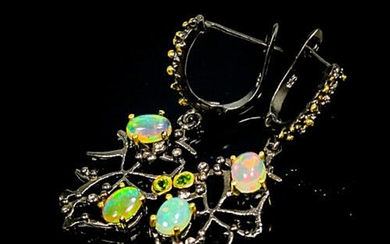 NOT SOLD. A pair of opal ear pendants each set with numerous cabochon opals and smaller peridots, mounted in black rhodium and gold plated sterling silver. – Bruun Rasmussen Auctioneers of Fine Art