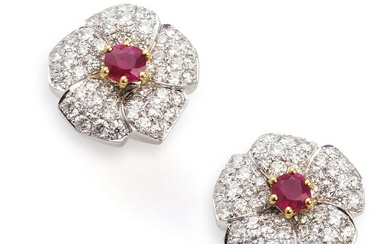 A pair of ruby and diamond ear studs each set with an...