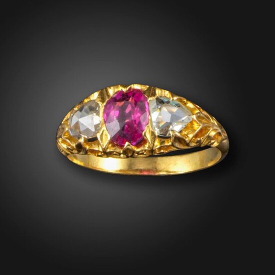 A pink sapphire and diamond three stone ring, the oval-shaped...