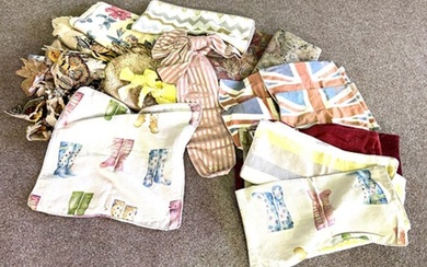 A quantity of cushions and decorative material including a gilt handled cloth bag, decorative