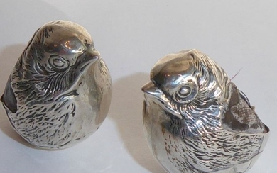A rare pair of Edwardian hallmarked silver pincushions modelled...