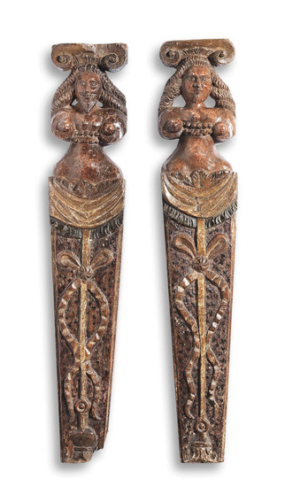 A rare pair of Elizabeth I/James I carved oak and polychrome-decorated figural pilasters, circa 1600