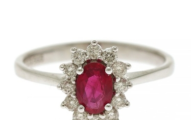 A ruby and diamond ring set with an oval-cut ruby encircled by numerous brilliant-cut diamonds totalling app. 0.26 ct., mounted in 14k white gold.