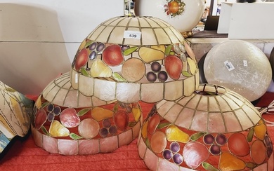 A set of three shell ceiling lamp shades with fruit design