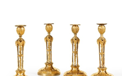 A suite of four gilt-bronze candlesticks attributed to Etienne Martincourt, late 18th-early 19th century | Suite de quatre flambeaux en bronze doré attribués à Etienne Martincourt, fin du XVIIIe - début du XIXe siècle